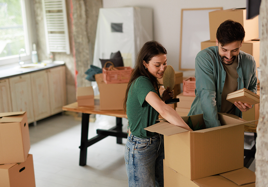 Couple in new home with moving boxes